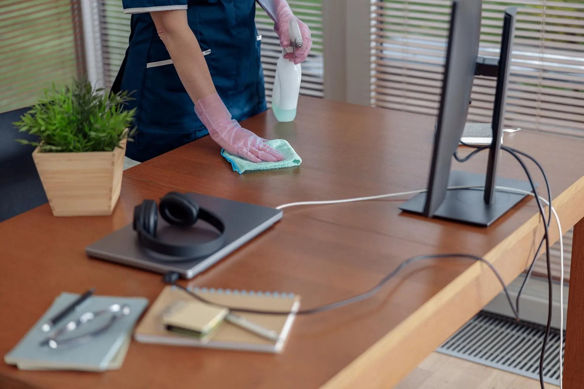 man cleaning an office desk